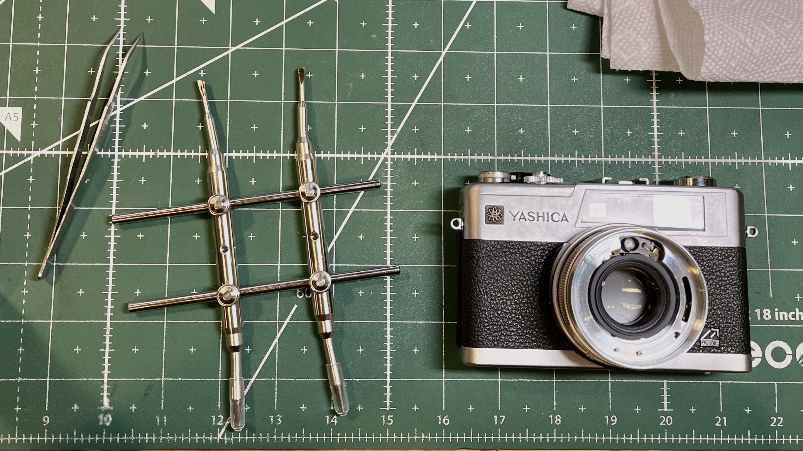 tweezer-like wrench for dissassembling camera